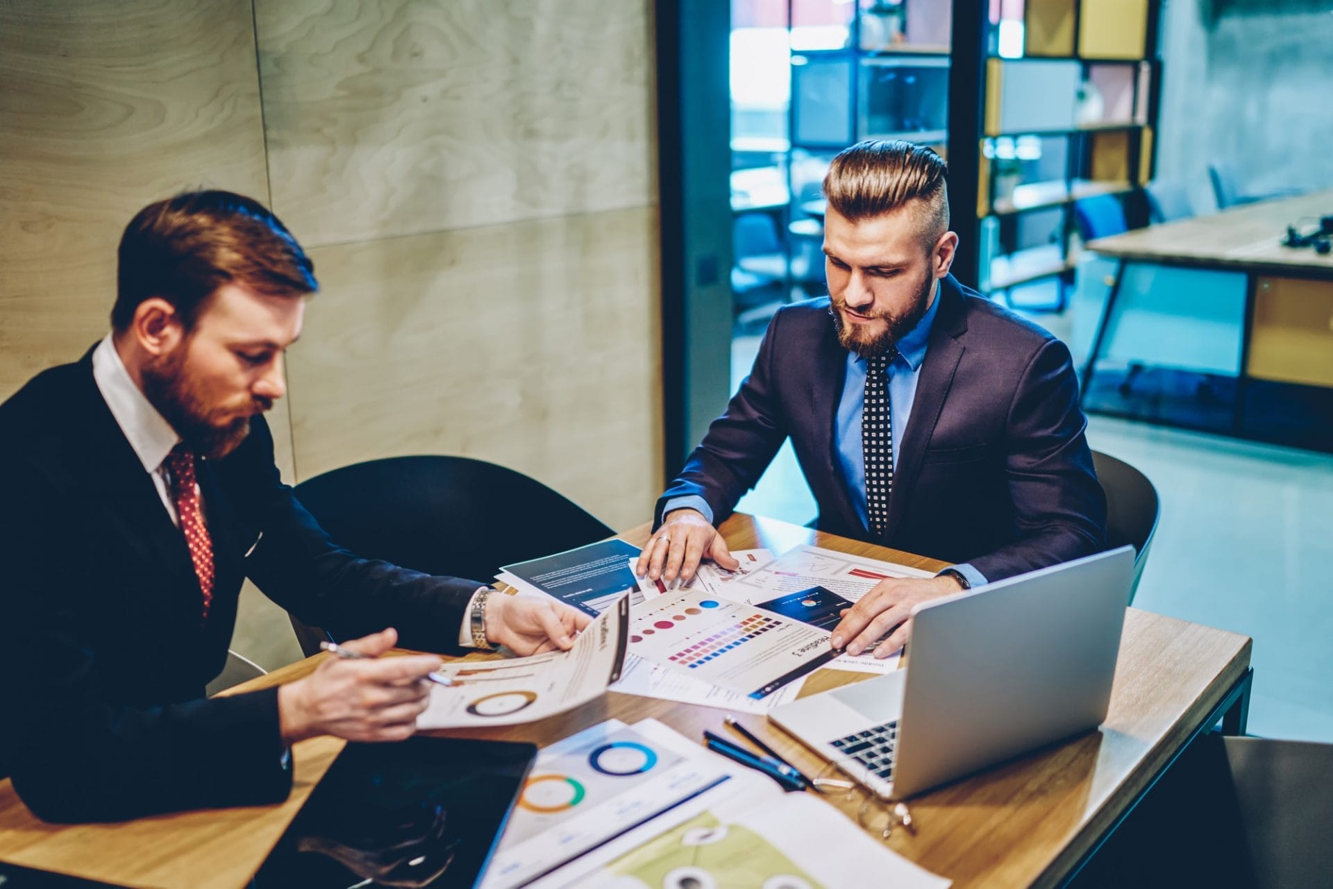 Businessman reviewing paperwork with colleague in office