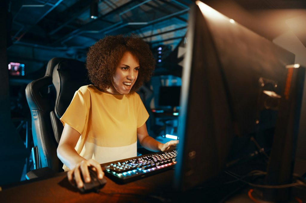 A young cyber gamer girl plays rpg games and shooters.